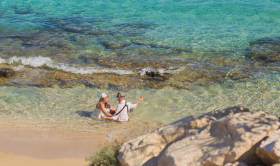 Fototapeta na wymiar honeymoon couple travel sea and beach resort in Europe. Bride and groom