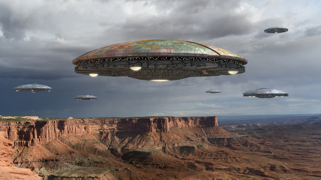 Alien spaceship fleet above the Grand Canyon, in Canyonlands, Utah, USA, for futuristic, fantasy and interstellar travel or war game backgrounds.
