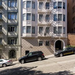 Fototapeta na wymiar Facade of residential buildings in San Francisco California USA. Angle of the roadpath on the streets of San Francisco
