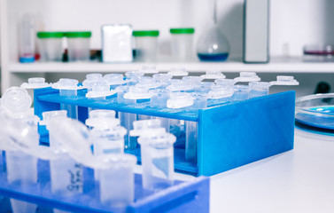Pipette adding fluid to one of several test tubes .medical glassware