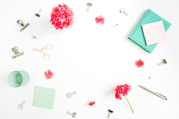 Flat lay fashion office desk with space for text. Female frame workspace with red flowers, accessories, mint diary on white background. Top view feminine background.