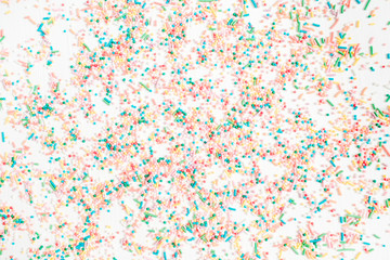 Colorful confetti pattern on white background. Celebration concept background. Flat lay, top view.