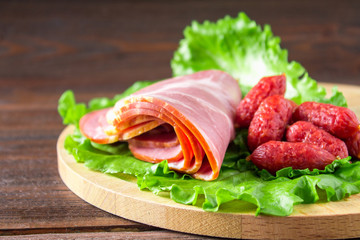 Assorted meat products including ham and sausages.