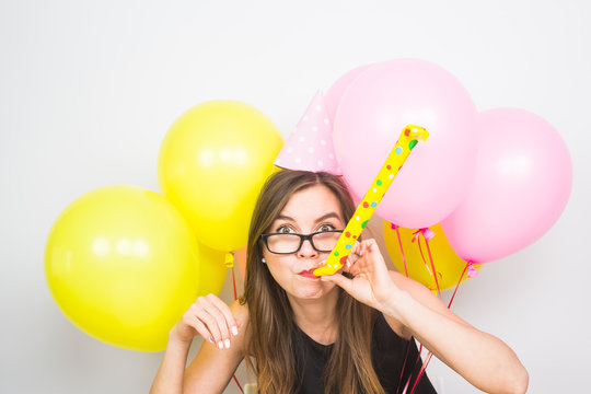 Young Woman With Party Hat With Noisemaker On A White Background