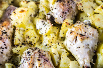 Roasted chicken leg with potatoes with caraway and garlic.