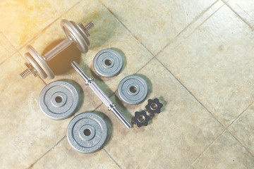 Iron Dumbbells on the floor showing all parts of it.