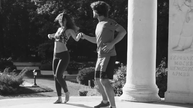 Young couple dancing on the square
