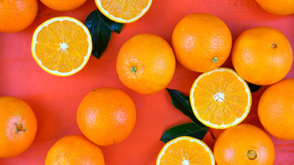 Oranges on orange wood table overhead.