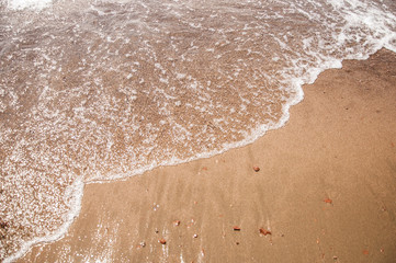 Sea beach in with white foam wave