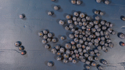 Blueberries on dark blue rustic wood table