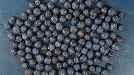 Blueberries on dark blue rustic wood table