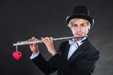 Male flutist with flute and heart. Love melody © anetlanda