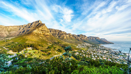Sun setting over Table Mountain, Camps Bay the Twelve Apostles. Viewed from the hiking trail to the top of Lions Head at Cape Town, South Africa