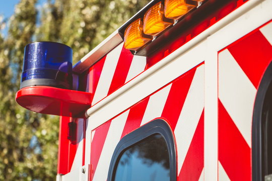 Blue Flashing Light On A Red Ambulance