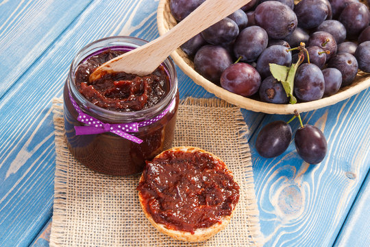 Knife and plum marmalade or jam for preparing sandwiches, healthy sweet snack concept