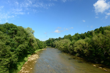 Fototapeta na wymiar Landscape with wild river and blue sky
