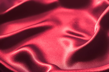 red wavy silk textile texture background selective focus