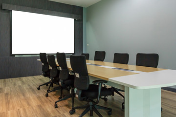 Blank projection screen in meeting room with conference table, Modern meeting room interior background