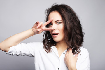 young lovely woman showing victory or peace sign