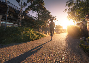 A woman running on a city sidewalk.