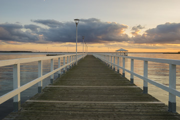 Fototapeta na wymiar Sunset on the lake, wooden, white pier
