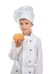 Small pretty chef holds delicious fresh sesame seed bun, on white background