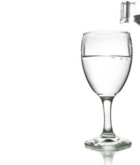 pouring water on a glass isolated on white background. Clipping path