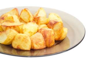 Fried potatoes on the dark glass dish