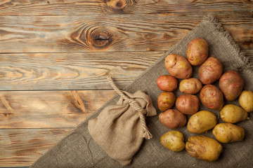 Potatoes on a rustic wooden background