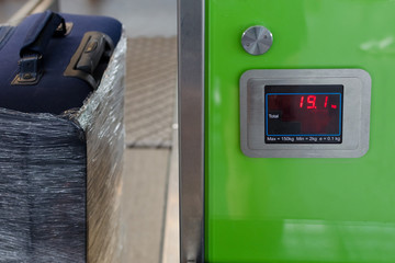 Checking the weight of luggage in the airport