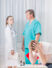 Fototapeta premium Sick man and doctors in the clinic