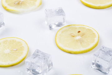 Ice cubes and lemon slices on the white background.