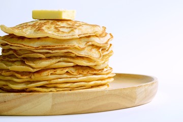 close up stack of pancakes and butter with white background