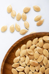 pumpkin seeds on the wood plate.