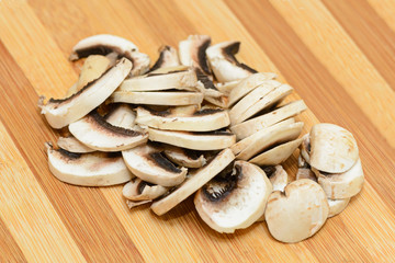 Chopped champignons on a wooden cutting board