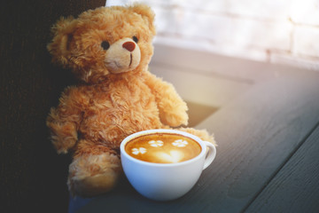 Cup of coffee and bear doll :