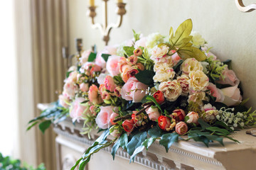 a bouquet of different flowers on the shelf