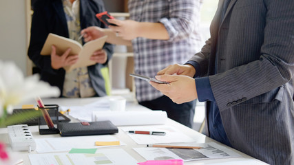 Business man talking to meeting making business decision in office with paper report on office desk.