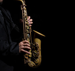Closeup saxophone in player action on a dark background
