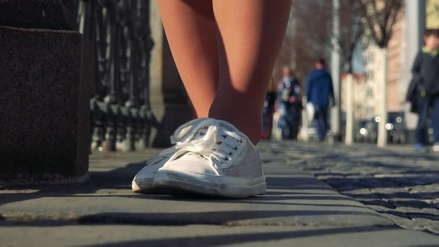 A Woman Shuffles Around In A Street - Closeup On The Feet