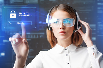Business, Technology, Internet and network concept. Technology future. Young businesswoman working in virtual glasses, select the icon Security Awareness on the virtual display