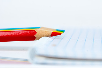 Obraz premium four colorful pencils with notepad, education concept