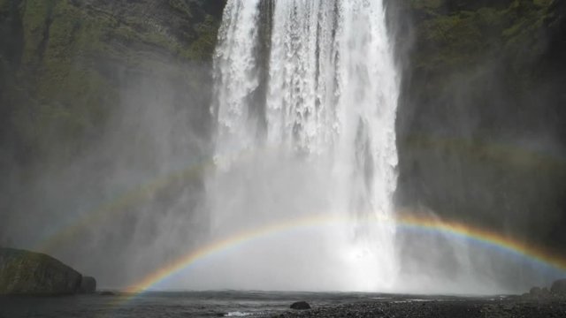 Skogafoss dramatic waterfall rainbow pool Iceland slow motion