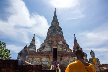 Thai old pagoda and buddha statue with blue sky