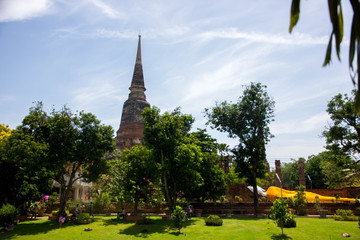Thai old pagoda with forest and buddha statue, wat yai chai mongkol, Ayutthaya, Thailand
