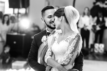 Groom holds bride carefully dancing in the smoke