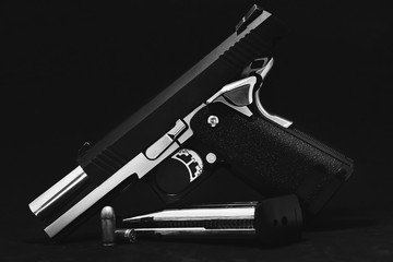 Carbon-based airsoft guns on the black background.Black and white image.