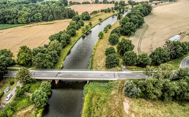 Aerial photo of a small river with a bridge between fields, Aller, nearness Celle, Germany