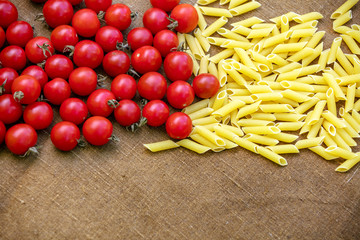 Cherry tomatoes and pasta on grunge sacking. 