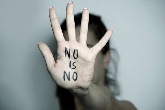 woman showing a note with the text no is no